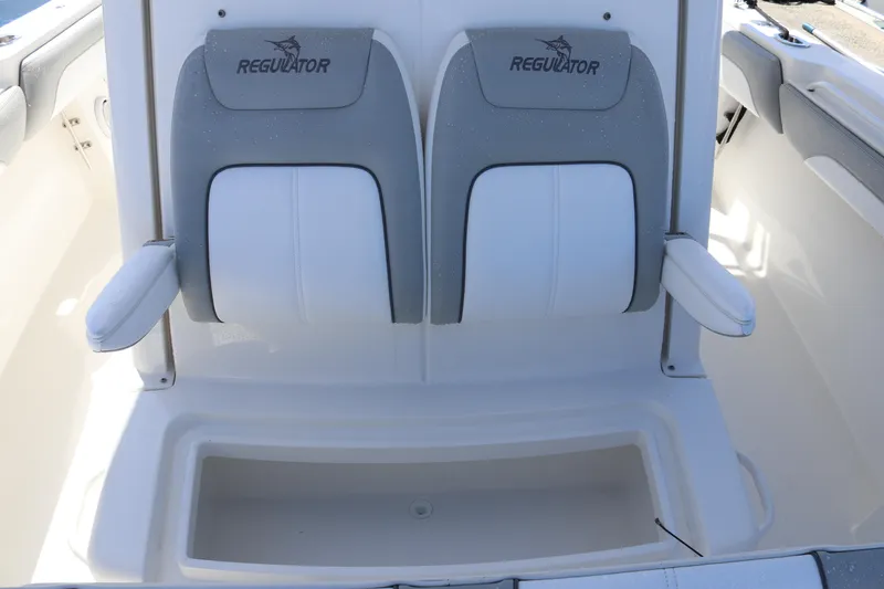Slide: The Image of 2020 Regulator 31 boat seating with armrests and storage compartment. - 26