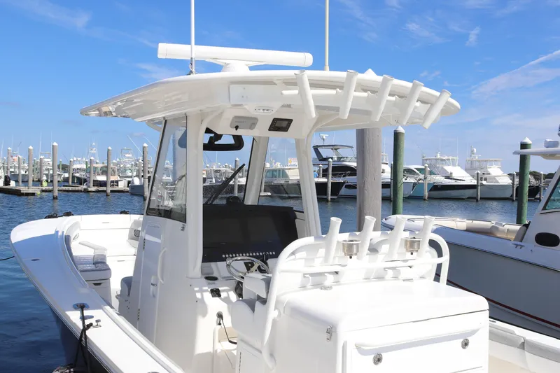 Slide: The Image of 2020 Regulator 31 boat docked at marina under clear blue sky. - 3