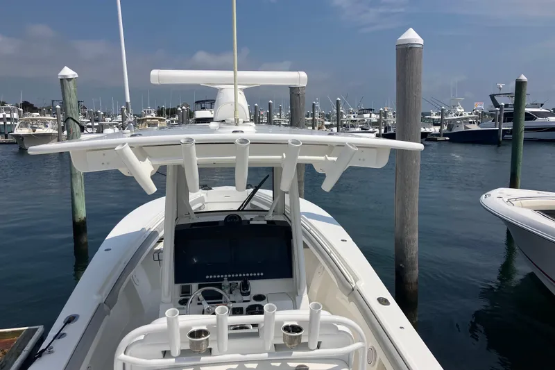 Slide: The Image of 2020 Regulator 31 boat docked in a marina, featuring a sleek console and T-top. - 4
