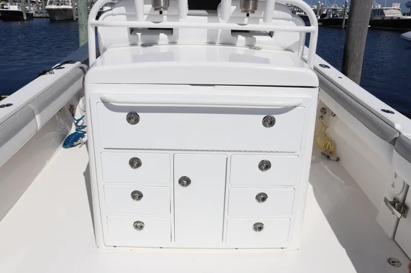 Slide: The Image of 2020 Regulator 31 boat interior with white storage drawers and ocean background. - 8
