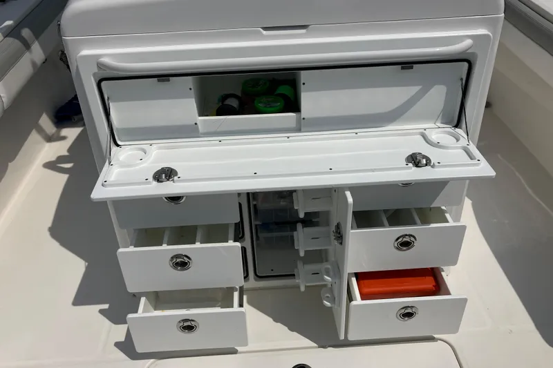 Slide: The Image of 2020 Regulator 31 boat storage compartment with open drawers and tackle storage. - 9