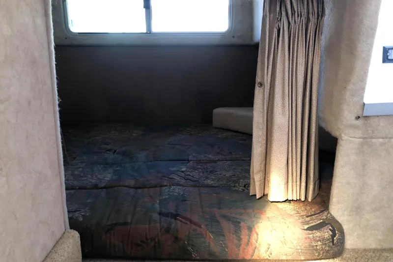 Slide: The Image of Interior cabin of 1992 Maxum 2300 SC boat with window and curtain. - 10