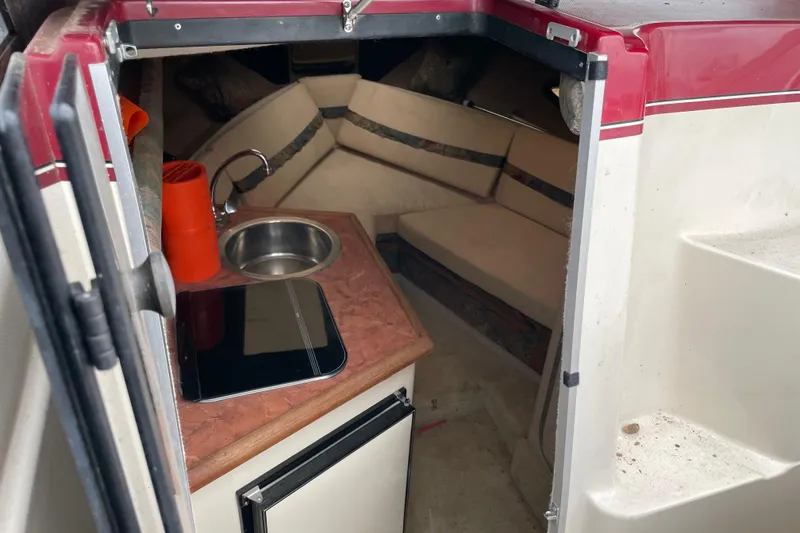 Slide: The Image of 1992 Maxum 2300 SC cabin interior with sink, countertop, and seating area. - 3