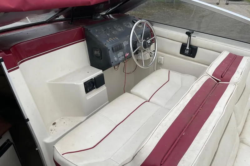 Slide: The Image of Interior of a 1992 Maxum 2300 SC boat with red and white seating. - 4