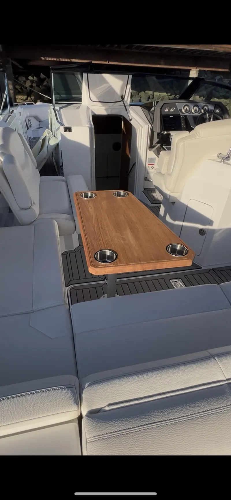 Slide: The Image of 2020 Cruisers Yachts 338OB interior with seating and wooden table. - 14