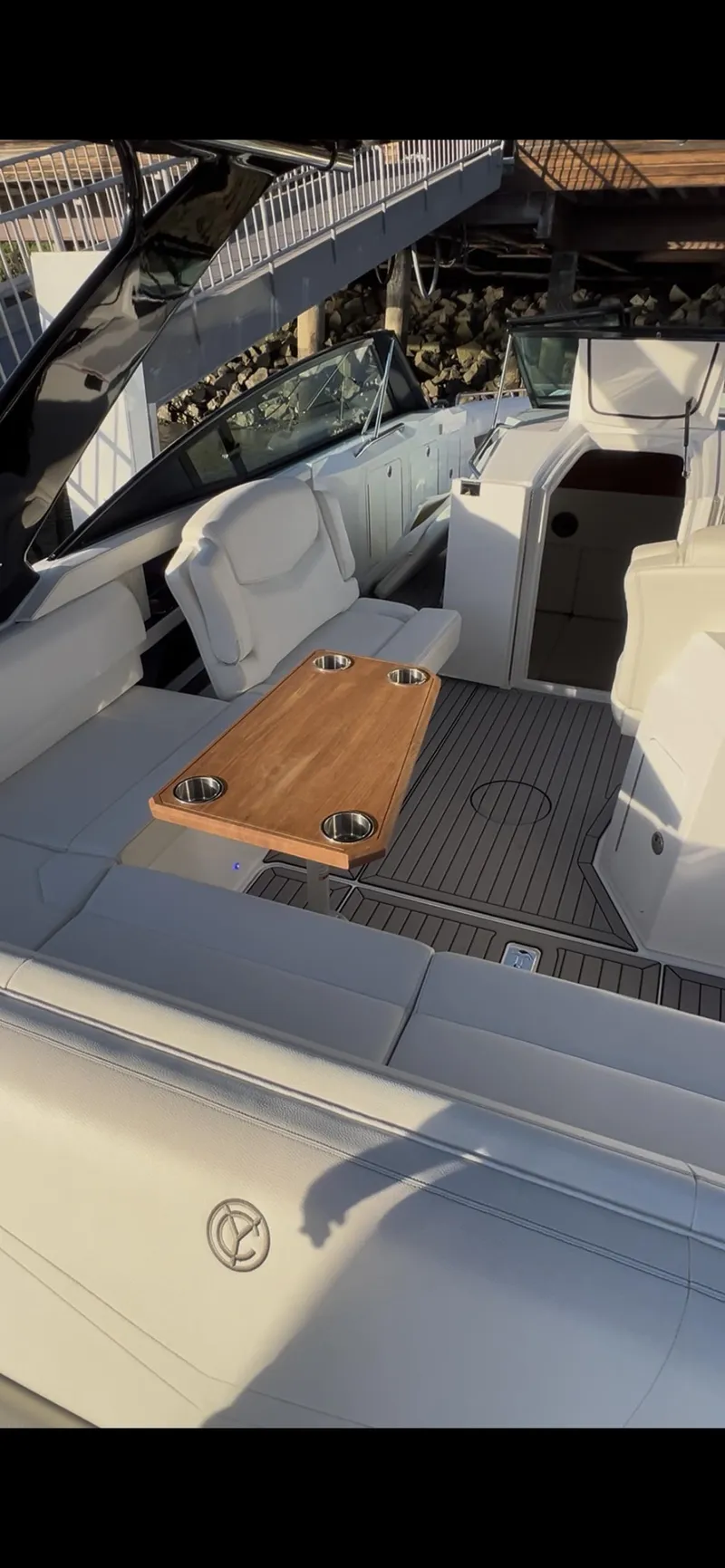 Slide: The Image of 2020 Cruisers Yachts 338OB at marina, featuring sleek design and luxurious seating. - 15