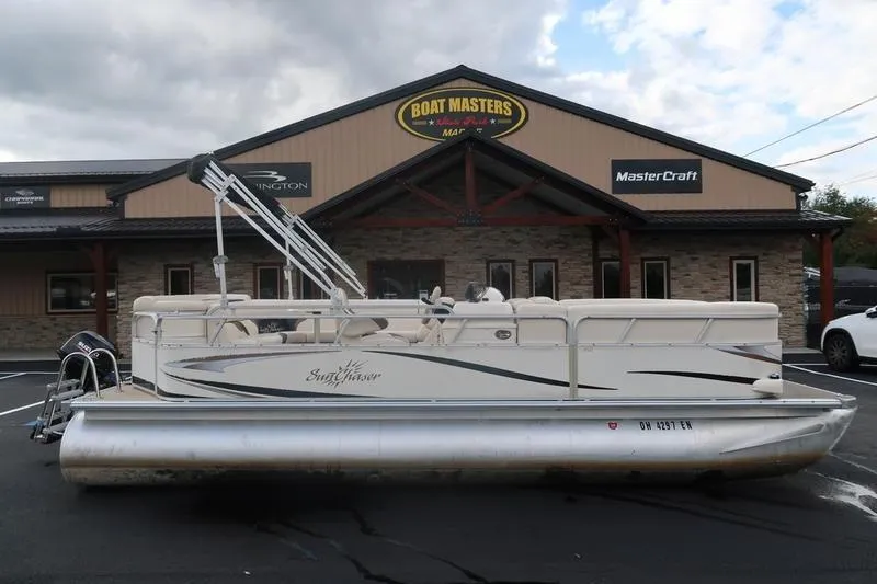 The Image of 2010 Smoker Craft Sunchaser 8522 pontoon boat parked at Boat Masters dealership. - 1