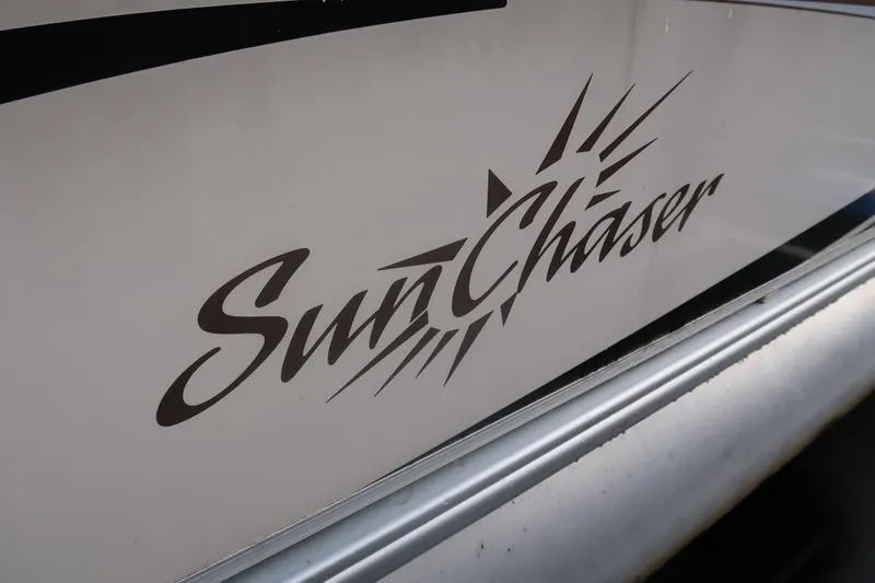 Slide: The Image of 2010 Smoker Craft Sunchaser 8522 logo on boat exterior. - 11
