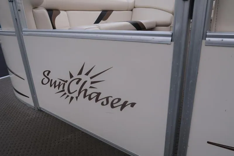 Slide: The Image of 2010 Smoker Craft Sunchaser 8522 pontoon boat with beige seating and logo. - 13
