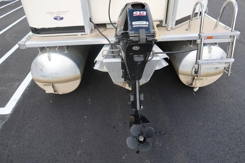 Slide: The Image of 2010 Smoker Craft Sunchaser 8522 pontoon boat with outboard motor in parking lot. - 15