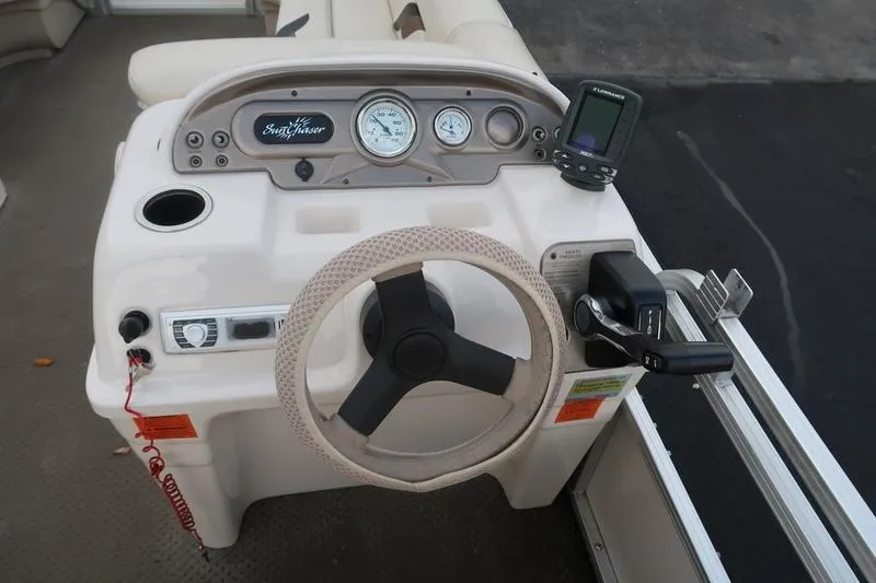 Slide: The Image of 2010 Smoker Craft Sunchaser 8522 boat dashboard with steering wheel and gauges. - 20