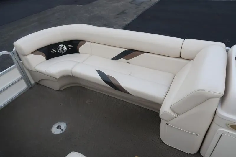 Slide: The Image of 2010 Smoker Craft Sunchaser 8522 boat interior with beige seating and stylish design. - 21