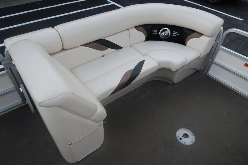 Slide: The Image of 2010 Smoker Craft Sunchaser 8522 boat interior with beige seating and speaker. - 22