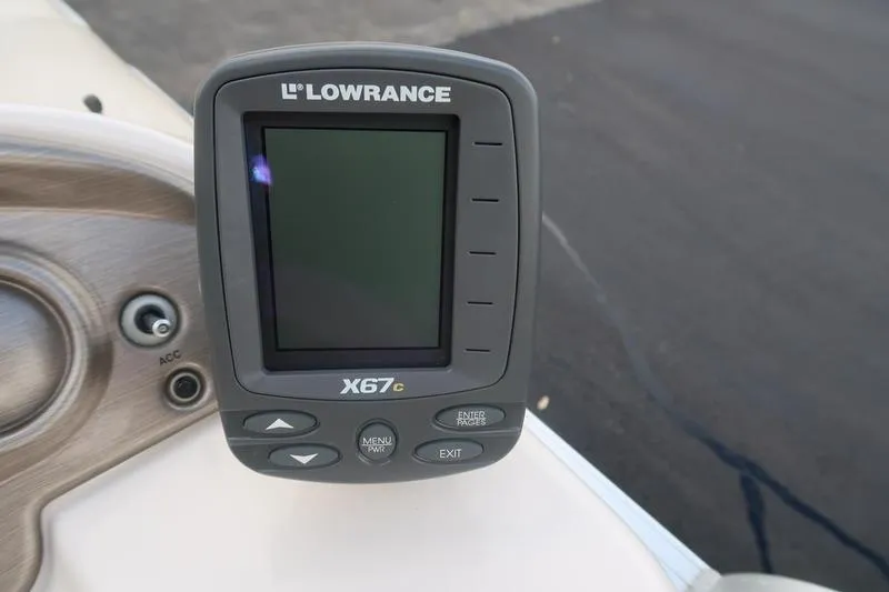 Slide: The Image of Lowrance X67c fishfinder on 2010 Smoker Craft Sunchaser 8522 boat dashboard. - 25
