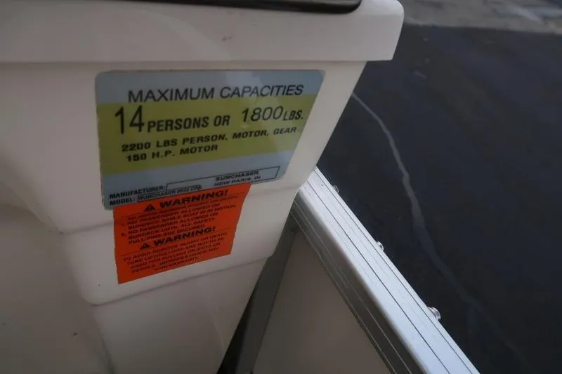 Slide: The Image of 2010 Smoker Craft Sunchaser 8522 capacity label, 14 persons or 1800 lbs limit. - 3