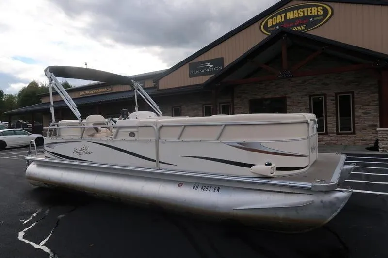Slide: The Image of 2010 Smoker Craft Sunchaser 8522 pontoon boat parked outside dealership. - 5