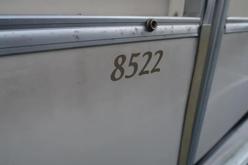 Slide: The Image of 2010 Smoker Craft Sunchaser 8522 boat exterior with model number visible. - 9