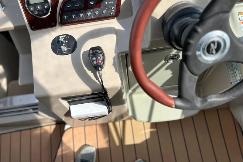 Slide: The Image of Control panel of 2008 Sea Ray 330 Sundancer boat with steering wheel and radio. - 13