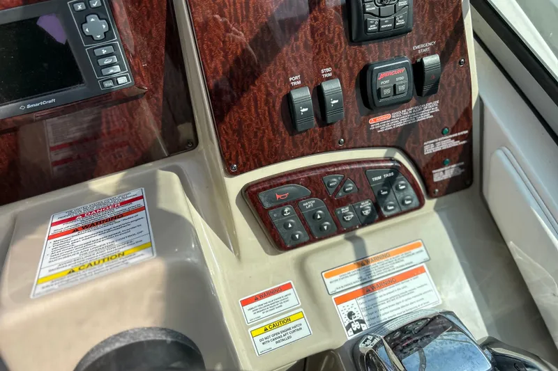 Slide: The Image of Control panel of a 2008 Sea Ray 330 Sundancer boat with various switches and warnings. - 15