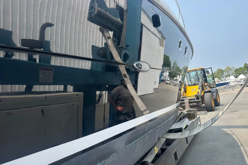 Slide: The Image of 2008 Sea Ray 330 Sundancer yacht in a boatyard with equipment and reflections. - 20