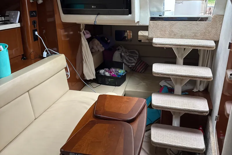 Slide: The Image of Interior of 2008 Sea Ray 330 Sundancer with seating, stairs, and storage area. - 26