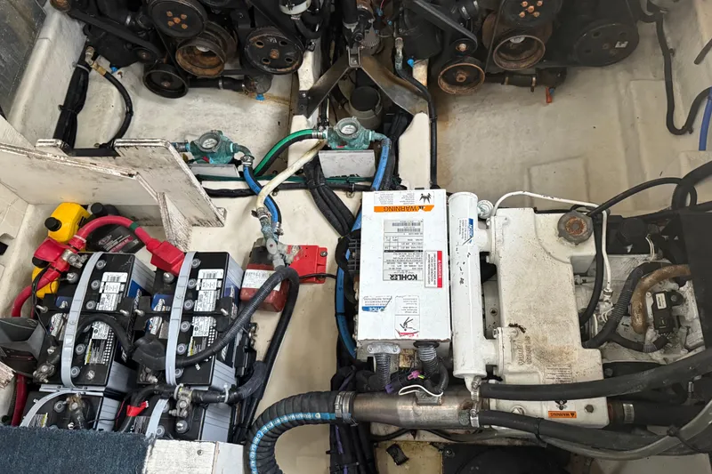 Slide: The Image of Engine compartment of a 2008 Sea Ray 330 Sundancer with batteries and mechanical components. - 27