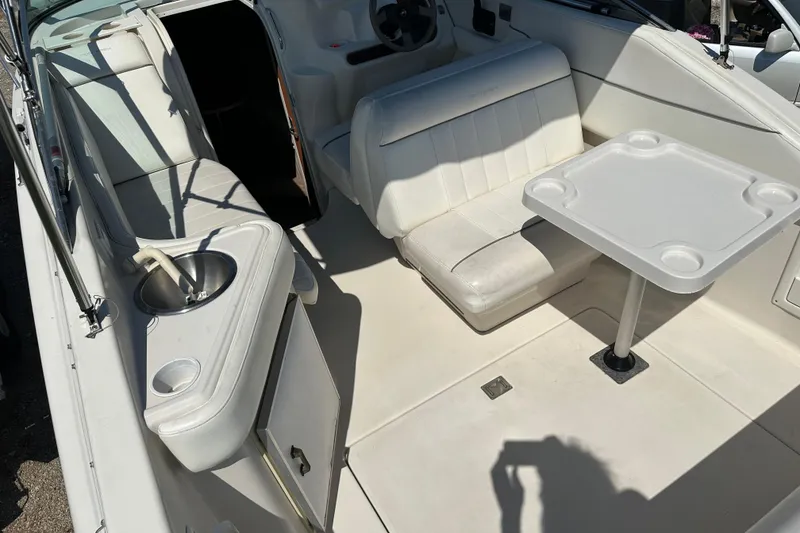 Slide: The Image of 1999 Monterey 262 Cruiser interior with seating, table, and sink. - 4
