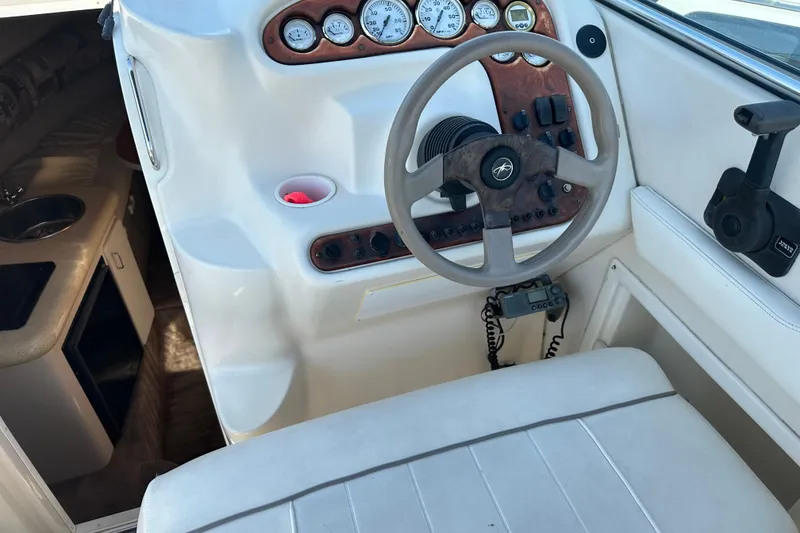 Slide: The Image of 1999 Monterey 262 Cruiser cockpit with steering wheel and cabin interior view. - 5