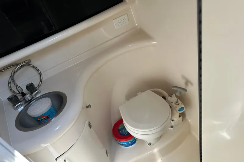 Slide: The Image of 1999 Monterey 262 Cruiser bathroom with sink and marine toilet. - 8