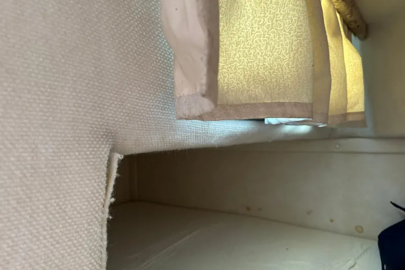 Slide: The Image of Interior cabin view of a 1999 Monterey 262 Cruiser with beige curtains. - 9