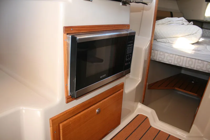 Slide: The Image of Interior of 2018 Ranger Tugs R-23 with microwave and cozy sleeping area. - 14