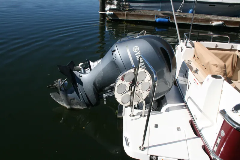Slide: The Image of 2018 Ranger Tugs R-23 with Yamaha outboard motor docked on calm water. - 16
