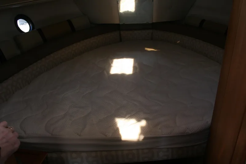 Slide: The Image of 2018 Ranger Tugs R-23 cabin interior with a cozy bed and soft lighting. - 20