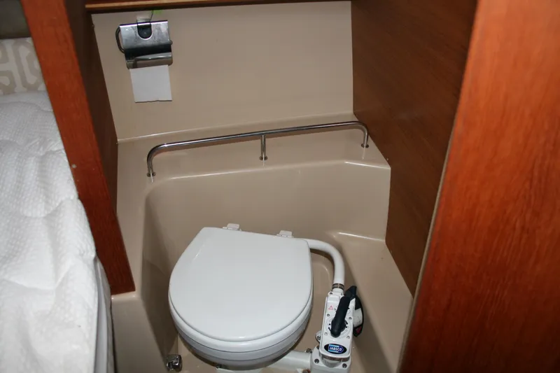 Slide: The Image of 2018 Ranger Tugs R-23 boat bathroom with toilet and paper holder. - 21