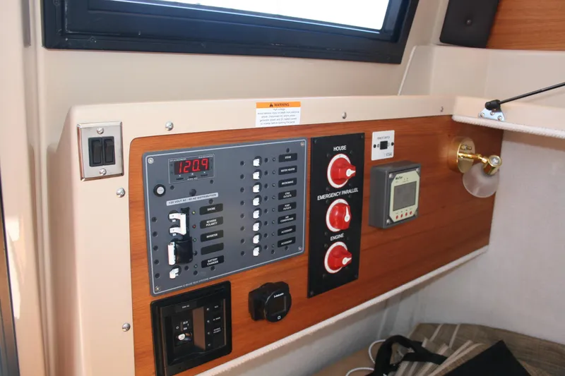 Slide: The Image of Control panel of a 2018 Ranger Tugs R-23 boat, featuring switches and gauges. - 23