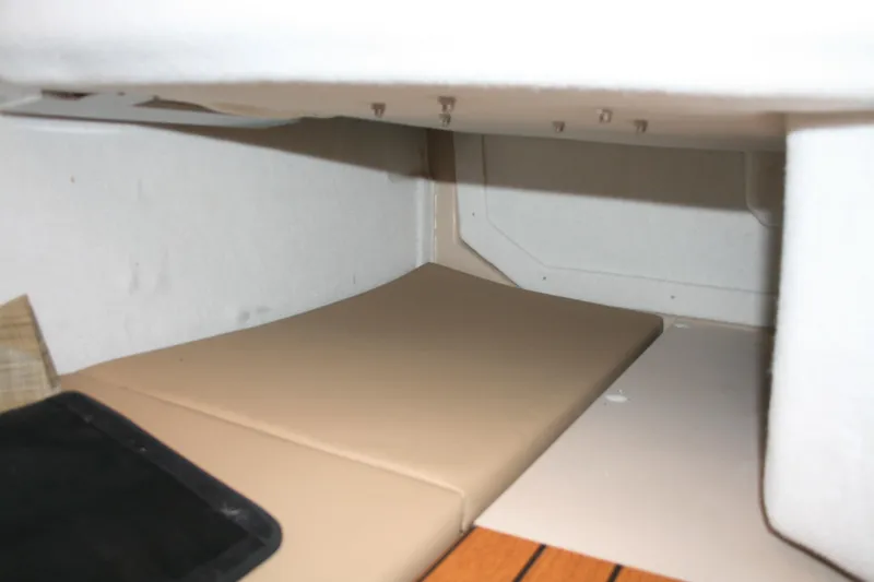 Slide: The Image of 2018 Ranger Tugs R-23 interior cabin with beige cushion and wooden flooring. - 24