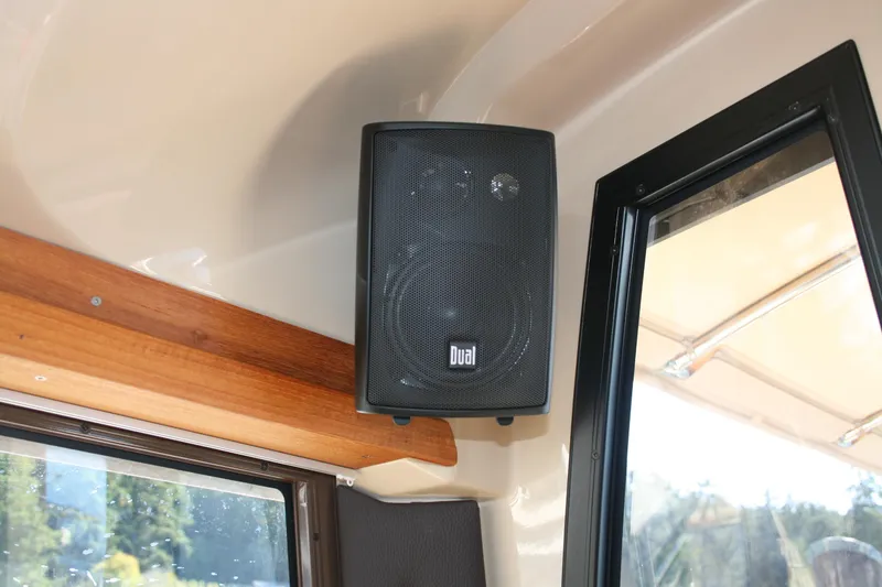 Slide: The Image of Speaker installed inside a 2018 Ranger Tugs R-23 boat, near a window. - 26