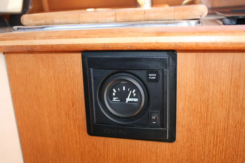 Slide: The Image of Water gauge and pump switch on 2018 Ranger Tugs R-23 boat interior. - 27