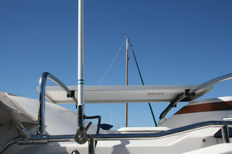 Slide: The Image of 2018 Ranger Tugs R-23 boat deck with solar panel and railing under clear blue sky. - 32