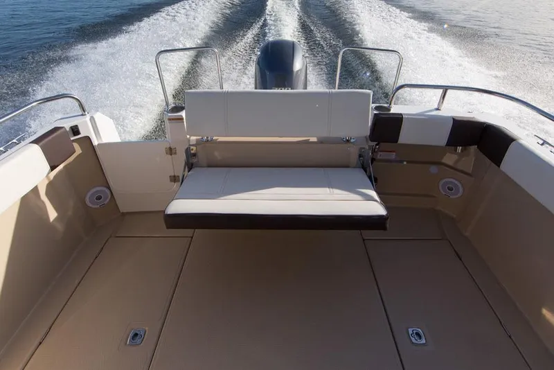 Slide: The Image of Manufacturer Provided Image: 2018 Ranger Tugs R-23 boat interior with rear seating and outboard motor. - 5