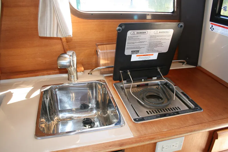 Slide: The Image of 2018 Ranger Tugs R-23 boat kitchen with sink and stove. - 7