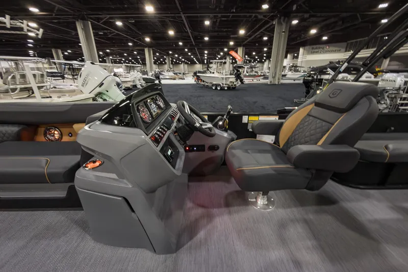 Slide: The Image of 2026 Godfrey Sweetwater 22' Tritoon interior with modern helm and luxurious seating. - 11