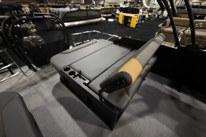 Slide: The Image of 2026 Godfrey Sweetwater 22' Tritoon with single flip lounge seating, showcased indoors. - 20