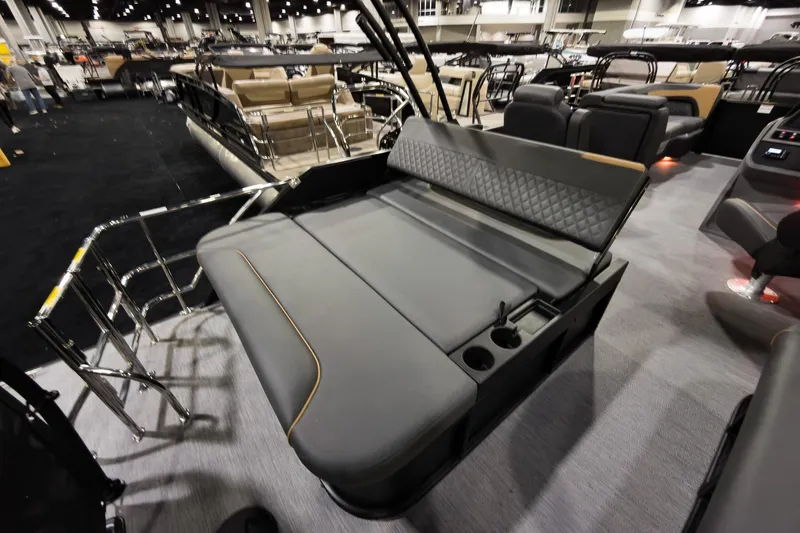 Slide: The Image of 2026 Godfrey Sweetwater 22' Tritoon with flip lounge seating, showcased indoors. - 21