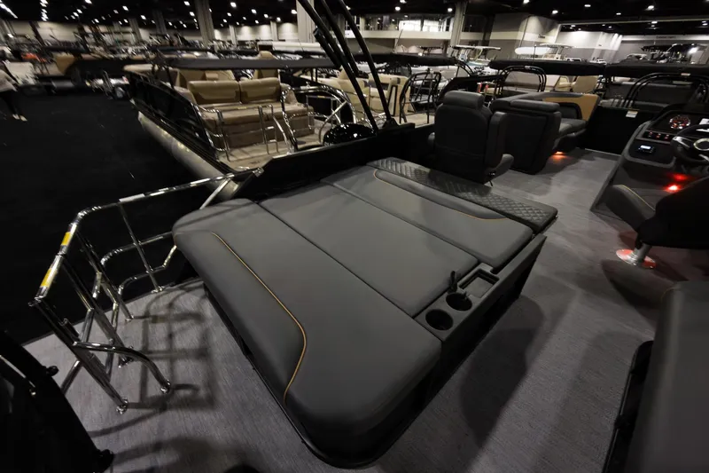 Slide: The Image of 2026 Godfrey Sweetwater 22' Tritoon interior with flip lounge seating and modern design. - 22