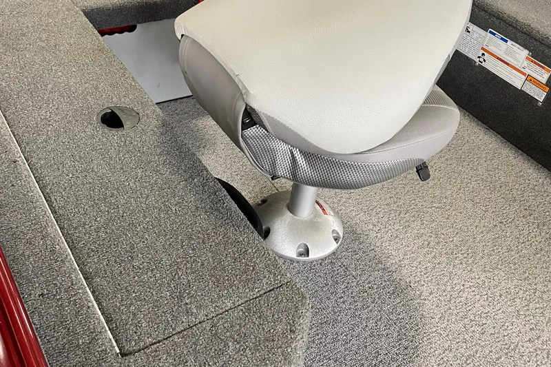 Slide: The Image of 2018 Alumacraft Classic 165 CS boat interior with gray seating and carpeted flooring. - 13