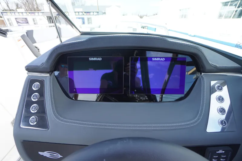 Slide: The Image of 2026 Chaparral 250 OSX dashboard with dual Simrad displays and control buttons. - 19