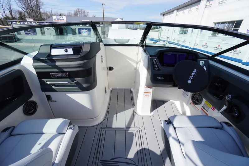 Slide: The Image of 2026 Chaparral 250 OSX boat interior with modern dashboard and seating. - 21