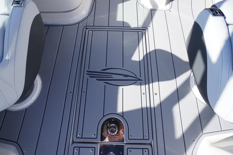 Slide: The Image of 2026 Chaparral 250 OSX boat interior with sleek seating and stylish flooring design. - 38