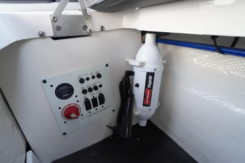 Slide: The Image of Control panel and equipment inside 2026 Chaparral 250 OSX boat interior. - 42